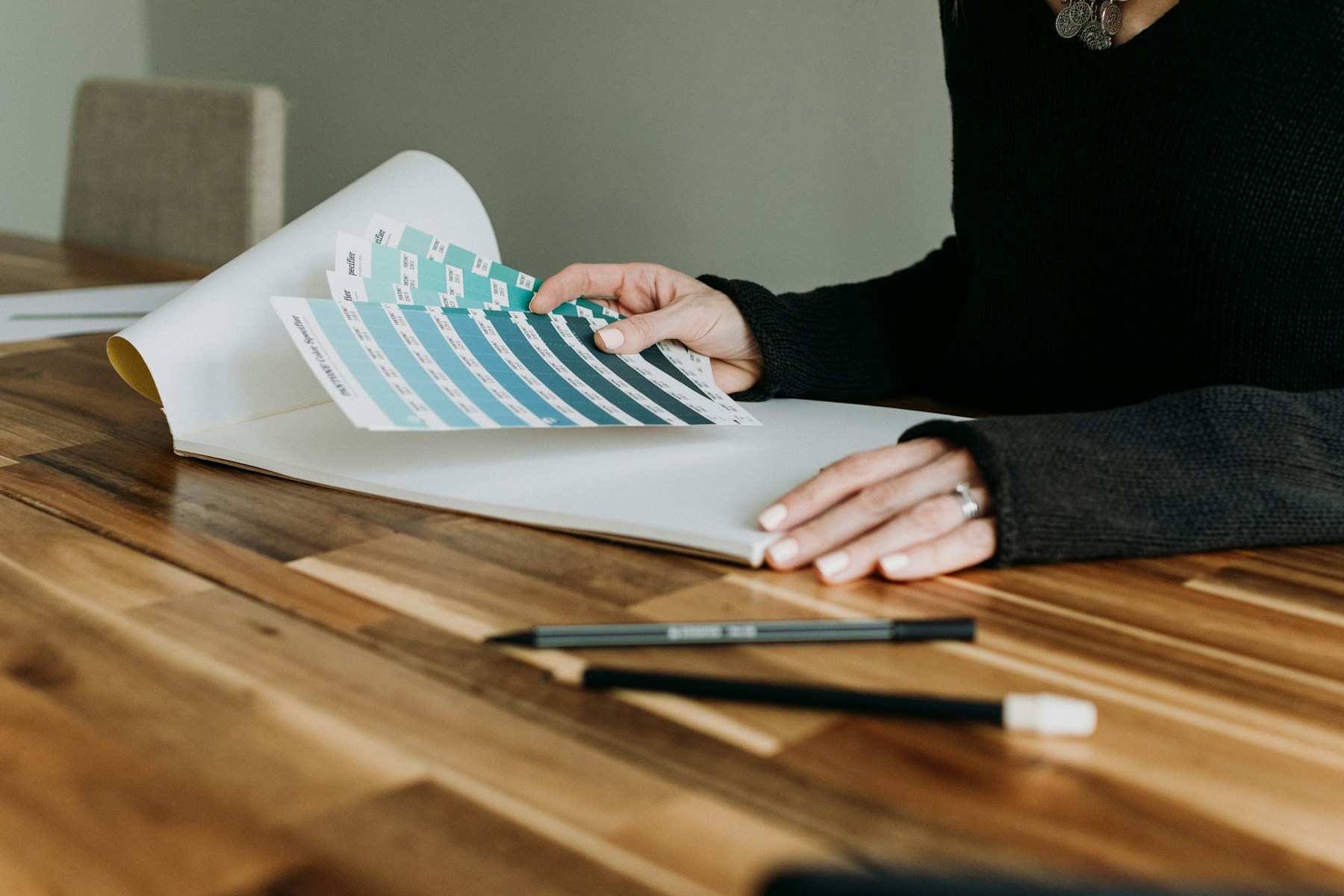 Designer reviewing plans and material notes at a desk